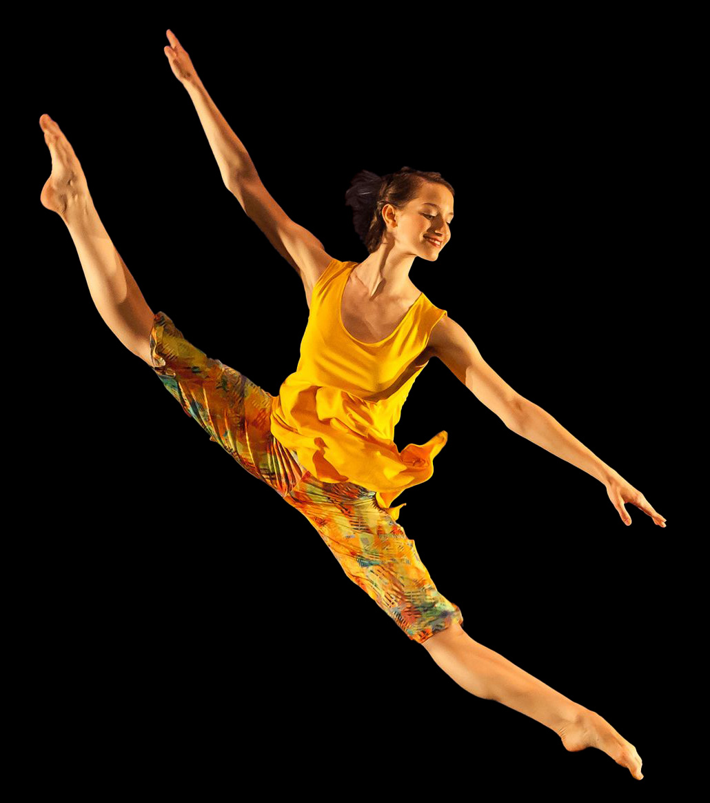 A smiling solo contemporary dancer in an exciting centre split leap hovering diagonally in the air.
