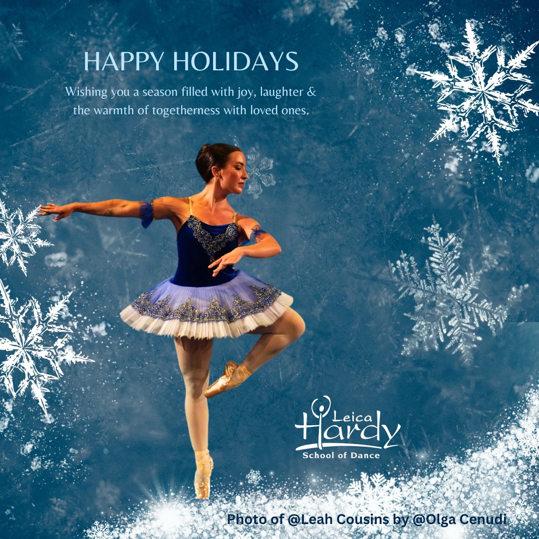 Ballet dancer in blue tutu performing on stage with snowflake background, wishing Happy Holidays from Leica Hardy School of Dance.