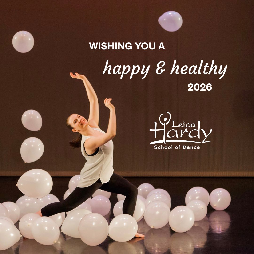 Dancer performing a contemporary movement among white balloons onstage, with text wishing a happy and healthy 2026 from Leica Hardy School of Dance.