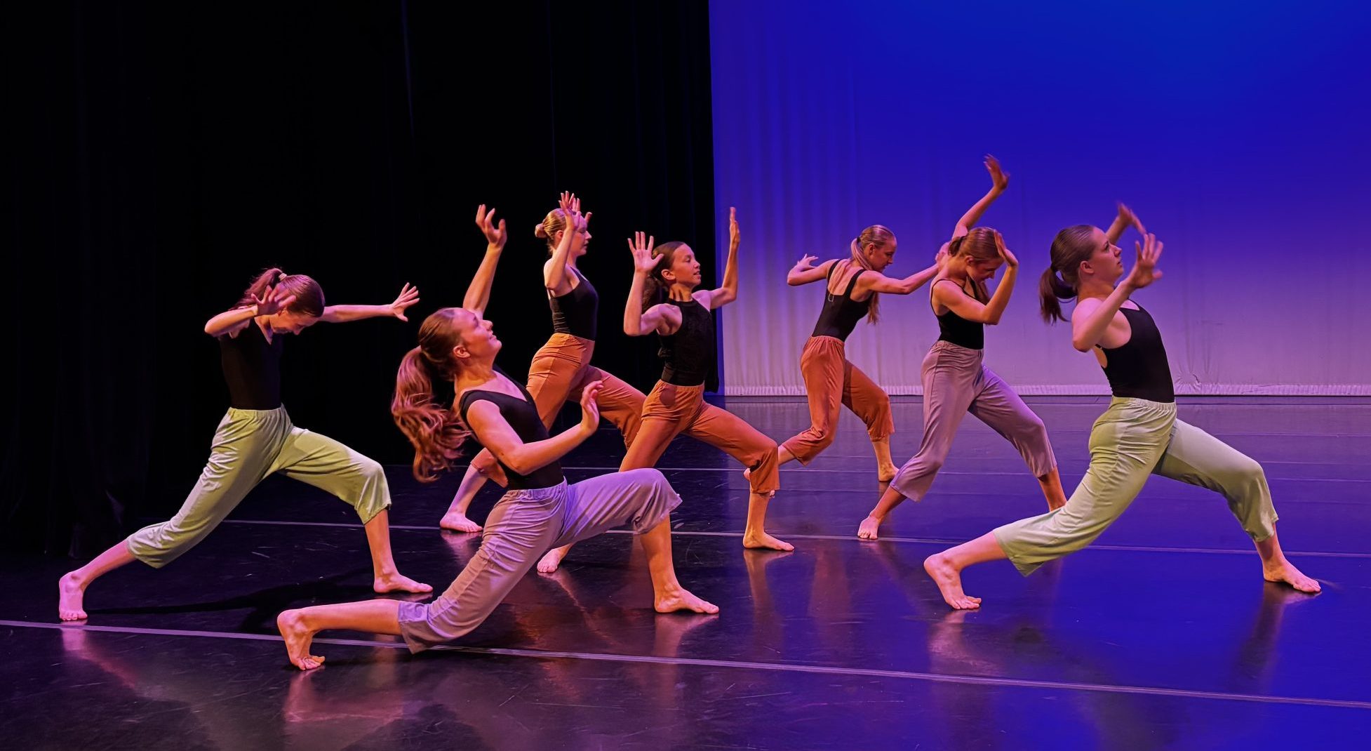 Group of contemporary dancers performing on stage in a studio selection guide.